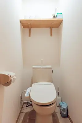 a bathroom with a toilet with a wooden shelf above it at hidden valley - Vacation STAY 40561v in Tokyo