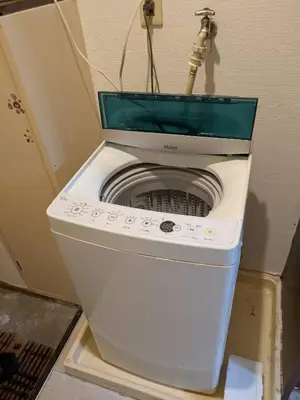 a washer and dryer sitting in a room at Wise Park Mukojima in Tokyo