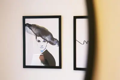 two framed pictures of a woman with a bird on her head at \u30aa\u30a6\u30eb\u30cf\u30a6\u30b9 in Tokyo