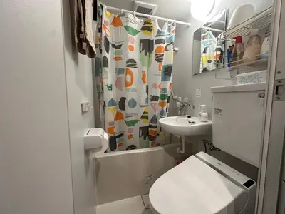 a small bathroom with a toilet and a sink at Hotel COMACHI in Tokyo