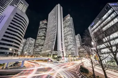 a city skyline with tall buildings at night at Duo Scala Shinjuku \u6771\u65b0\u5bbf in Tokyo