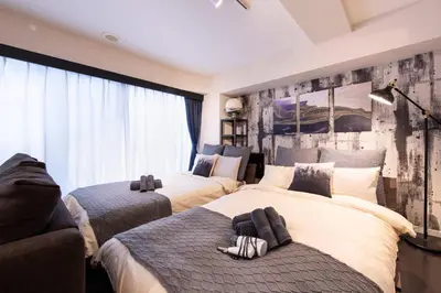 a bedroom with two beds and a large window at \u30ea\u30ce\u30b9\u30bf\u30a4\u30eb\u62bc\u4e0a in Tokyo