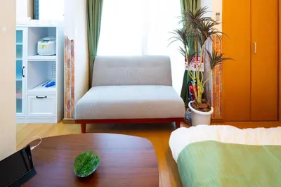 a living room with a chair and a table at \u8981\u753a \u4e00\u6238\u5efa\u8cb8\u5bb6 in Tokyo