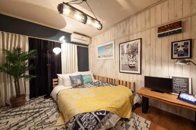 a bedroom with a bed and a desk with a television at \u30d1\u30eb\u30b3\u30fc\u30c8\u6c60\u888b in Tokyo