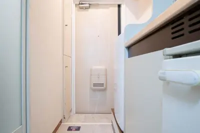 a small bathroom with a soap dispenser on the wall at \u30d1\u30f3\u30b7\u30aa\u30f3\u62bc\u4e0a in Tokyo