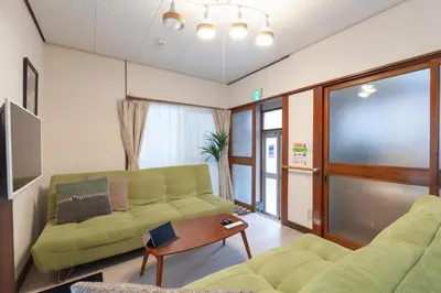 a living room with a couch and a table at \u6e0b\u8c37\u672c\u753a4\u4e01\u76ee\u6238\u5efa in Tokyo