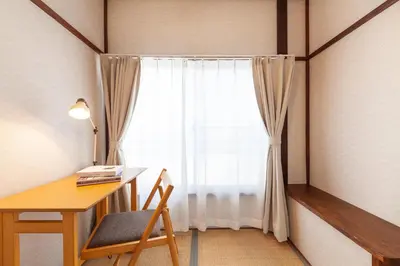 a room with a desk and a window with a chair at \u6e0b\u8c37\u672c\u753a4\u4e01\u76ee\u6238\u5efa in Tokyo