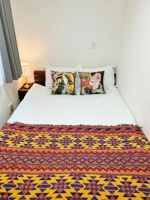 a bedroom with a bed with a colorful blanket on it at Tokyo Private villa/near station/Ginza/Asakusa/Sky Tree/Louis House in Tokyo