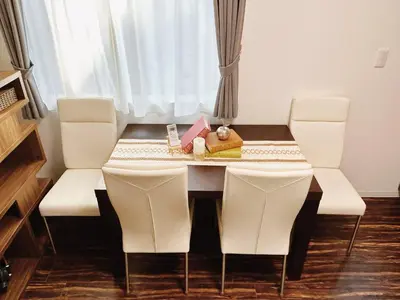 a dining room with a table and white chairs at Tokyo Private villa/near station/Ginza/Asakusa/Sky Tree/Louis House in Tokyo