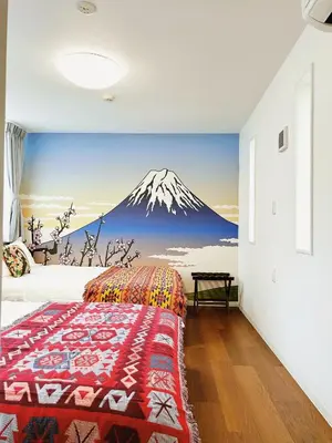 a bedroom with a mountain mural on the wall at Tokyo Private villa/near station/Ginza/Asakusa/Sky Tree/Louis House in Tokyo