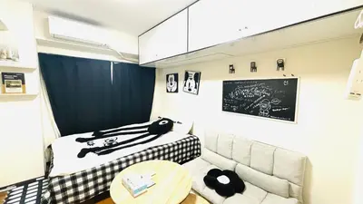 a room with a couch and a table and a chalkboard at \u5de3\u9d28 \u6700\u59274\u4eba in Tokyo