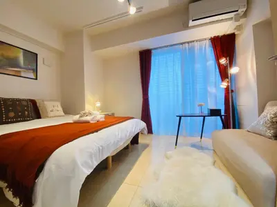 a bedroom with a bed and a window at shinjuku1 in Tokyo