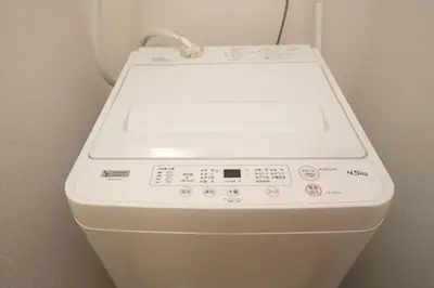 a white washing machine sitting in a bathroom at shinjuku1 in Tokyo