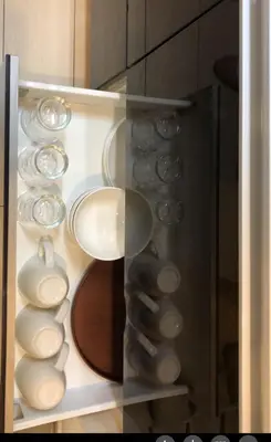 a cabinet filled with bowls and plates on display at shinjuku1 in Tokyo