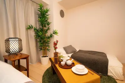 a living room with a bed and a coffee table at shinjuku1 in Tokyo