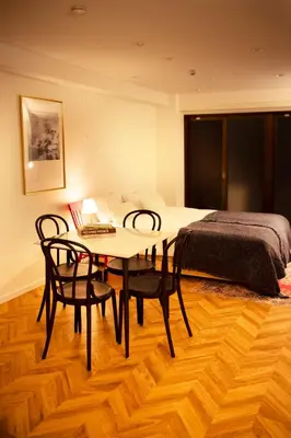 a bedroom with a table and chairs and a bed at #4New open 3stops to Shinjuku spacious stylish apartment in Tokyo