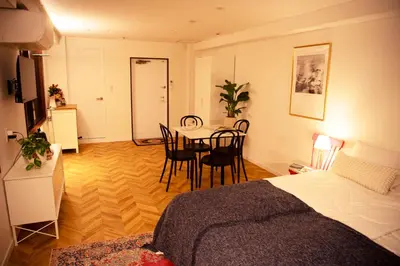 a room with a bed and a table and chairs at #4New open 3stops to Shinjuku spacious stylish apartment in Tokyo