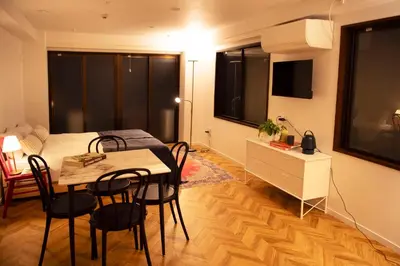 a room with a table and a bed and a bedroom at #4New open 3stops to Shinjuku spacious stylish apartment in Tokyo