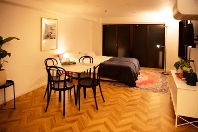 a bedroom with a bed and a table and chairs at #4New open 3stops to Shinjuku spacious stylish apartment in Tokyo