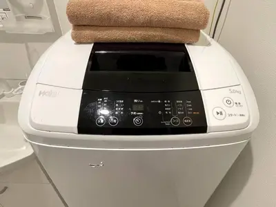 a washing machine with a towel on top of it at COMMA HOUSE Nishi-ikebukuro 2223 in Tokyo