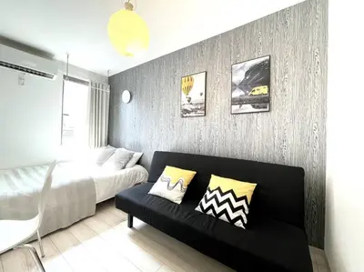 a bedroom with a bed and a couch in it at COMMA HOUSE Nishi-ikebukuro 2223 in Tokyo