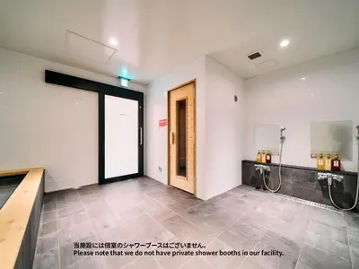 a room with a bathroom with a shower and a door at Hotel Plus Hostel TOKYO ASAKUSA 1 in Tokyo