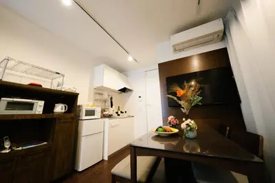 a small kitchen with a table with a bowl of fruit on it at FL Residence Shinjuku Kawadacho in Tokyo