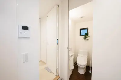 a white bathroom with a toilet and a sink at FL Residence Shinjuku Kawadacho in Tokyo