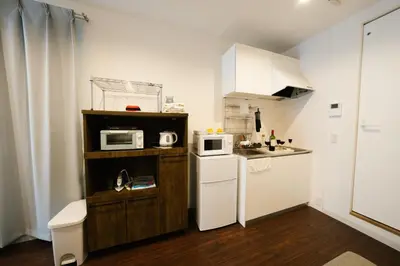 a small kitchen with a sink and a microwave at FL Residence Shinjuku Kawadacho in Tokyo