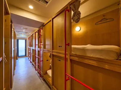 a row of bunk beds in a train room at Hotel Plus Hostel TOKYO ASAKUSA 2 in Tokyo