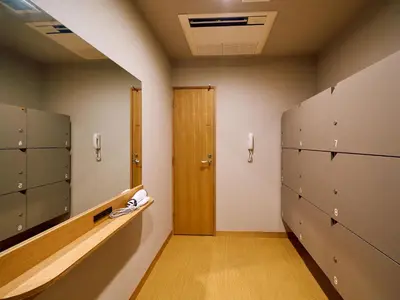 a locker room with a hallway with a door at Hotel Plus Hostel TOKYO ASAKUSA 2 in Tokyo
