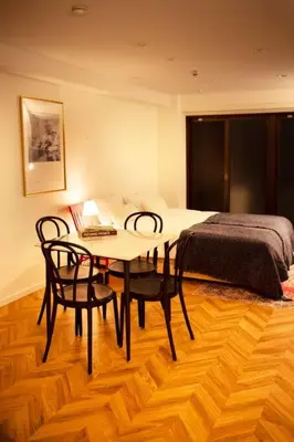 a bedroom with a table and chairs and a bed at #5 3stops to Shinjuku station stylish spacious studio apartment in Tokyo