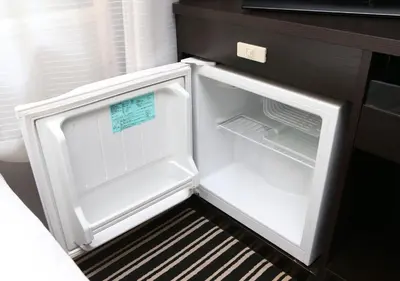 an empty refrigerator with its door open in a kitchen at APA Hotel Shinjuku Gyoemmae in Tokyo