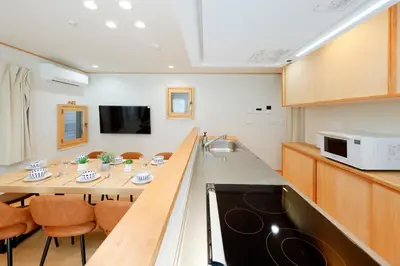 a kitchen and dining room with a table and chairs at Convertel Daita by Tranova in Tokyo