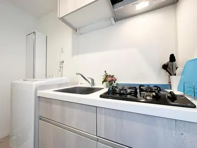 a white kitchen with a sink and a stove at nestay apartment tokyo waseda in Tokyo