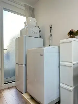 two white refrigerators in a room with a window at nestay apartment tokyo waseda in Tokyo