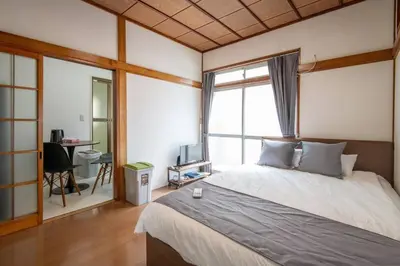 a bedroom with a bed and a desk and a window at 2023年8月オープン/入谷駅から徒歩10分/収容人数6/浅草寺徒歩10分/上野駅タクシー7分2km in Tokyo