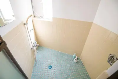 a bathroom with a shower with a blue tile floor at 2023年8月オープン/入谷駅から徒歩10分/収容人数6/浅草寺徒歩10分/上野駅タクシー7分2km in Tokyo