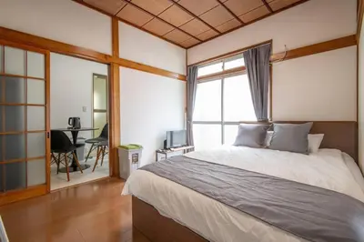 a bedroom with a bed and a desk and a window at 2023年8月オープン/入谷駅から徒歩10分/収容人数6/浅草寺徒歩10分/上野駅タクシー7分2km in Tokyo