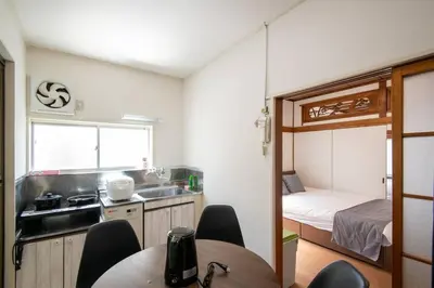 a small kitchen with a table and a bed at 2023年8月オープン/入谷駅から徒歩10分/収容人数6/浅草寺徒歩10分/上野駅タクシー7分2km in Tokyo