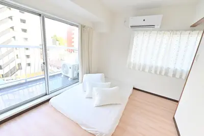a white room with a white couch and a large window at Ueno Luxury 161m2 Villa 6BR 3Bath 4Toilet 3m to Train Skytree View in Tokyo