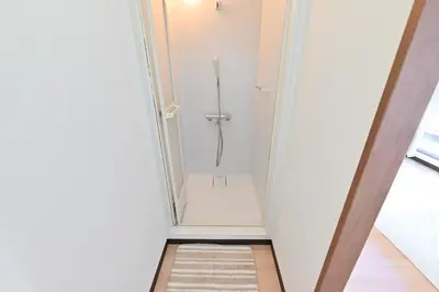 a bathroom with a shower in a white room at Ueno Luxury 161m2 Villa 6BR 3Bath 4Toilet 3m to Train Skytree View in Tokyo