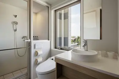 a bathroom with a sink and a toilet and a window at Four Points Flex by Sheraton Tokyo Ueno in Tokyo