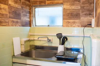 a kitchen sink with a utensil holder next to it at Yoyogi Apartment 1-401 by Tranova in Tokyo