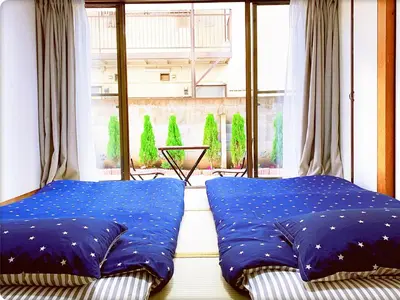 a bed in a room with a large window at TOKYO/Shinjuku & Shibuya 10mins/5mins walk to subway stiaon/Kichijoji 15mins/Shimokitazawa 5mins/Louis House in Tokyo
