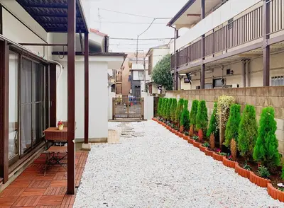 a walkway with a row of plants on a building at TOKYO/Shinjuku & Shibuya 10mins/5mins walk to subway stiaon/Kichijoji 15mins/Shimokitazawa 5mins/Louis House in Tokyo