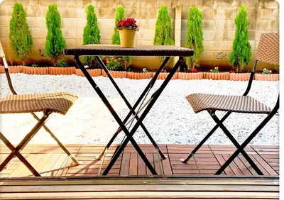 a table and two chairs sitting on a patio at TOKYO/Shinjuku & Shibuya 10mins/5mins walk to subway stiaon/Kichijoji 15mins/Shimokitazawa 5mins/Louis House in Tokyo