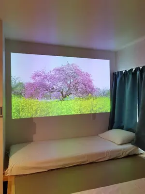a bedroom with a large picture of a purple tree at belle via tokyo - Vacation STAY 60795v in Tokyo