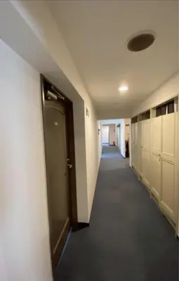 a hallway of an office building with a door and a hallwayngthngthngthngth at Hotel Yuni Star-Club in Tokyo