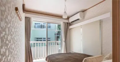 a bedroom with a bed and a large window at \u7b39\u585a\u6238\u5efa in Tokyo